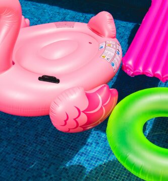 pink inflatable flamingo and green inflatable ring